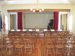 Town Meeting Hall, One Hour Before Meeting